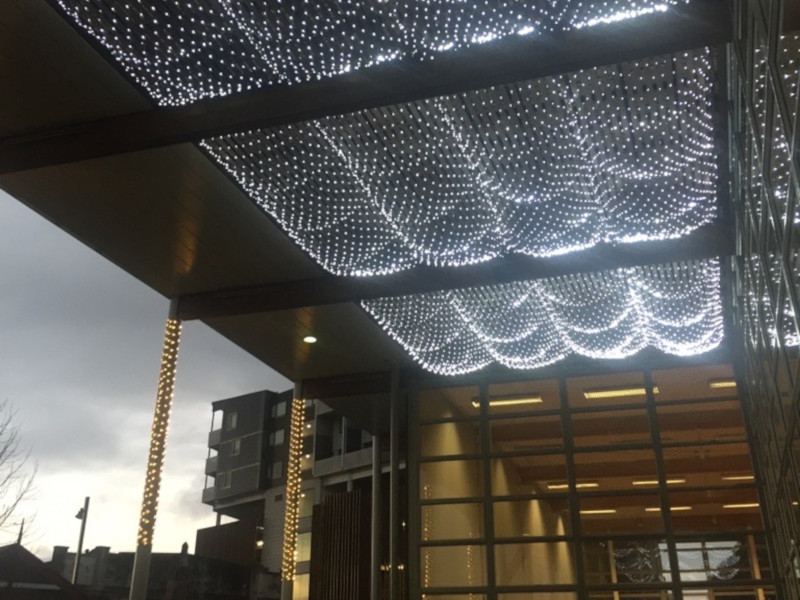 Pure white fairy light nets on ceiling decorating a community centre